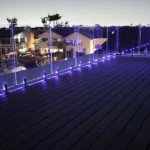 IG Railing Frameless Illuminated Glass Railing System lit up purple at night.